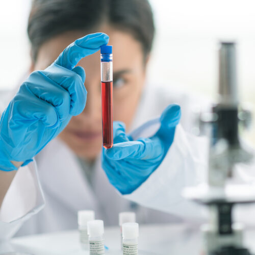 A woman holding a test tube